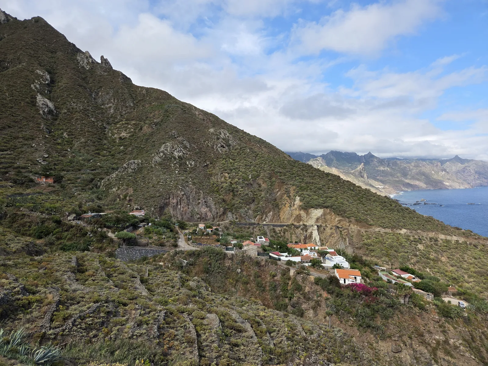 Caserío de El Draguillo entre bancales y montañas frente al Atlántico